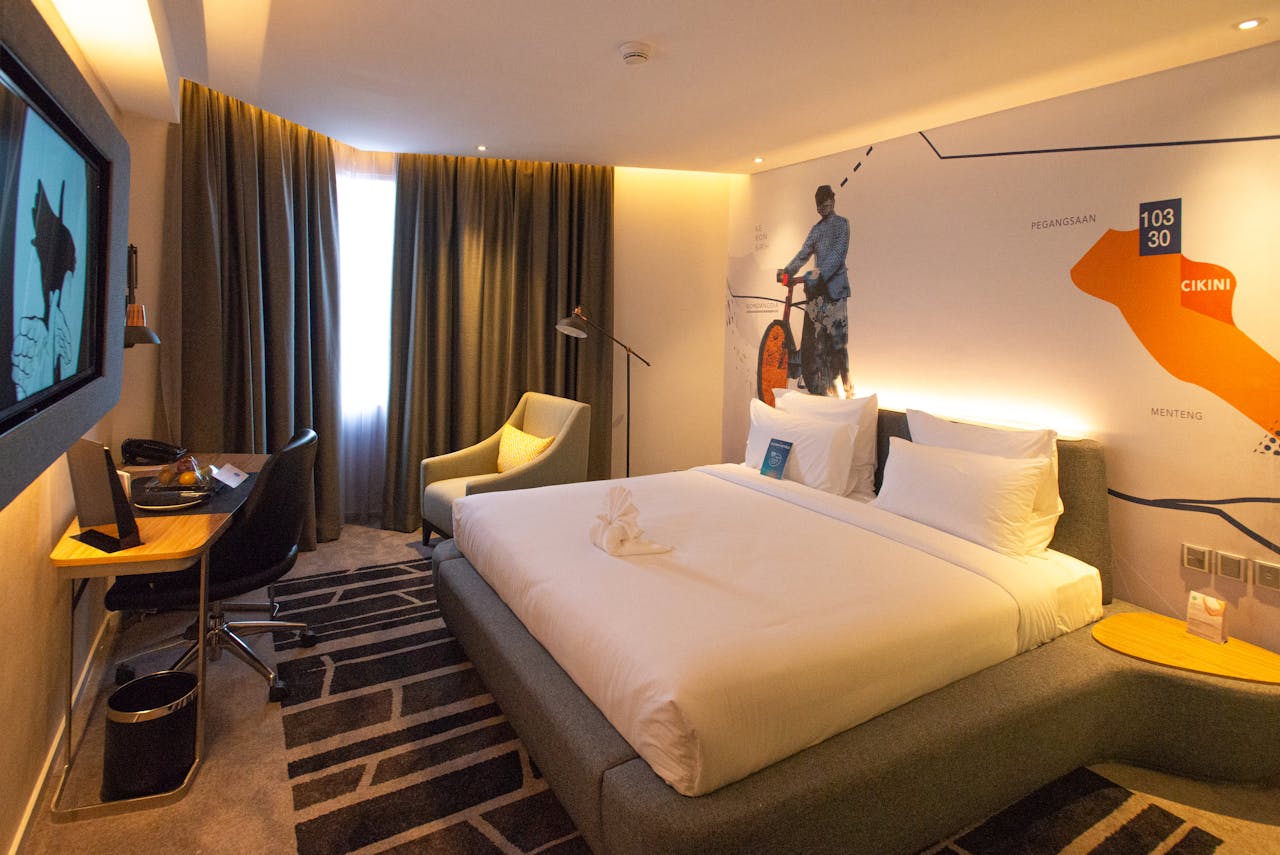 Modern hotel room interior in South Jakarta, offering cozy ambiance with warm lighting and stylish decor.